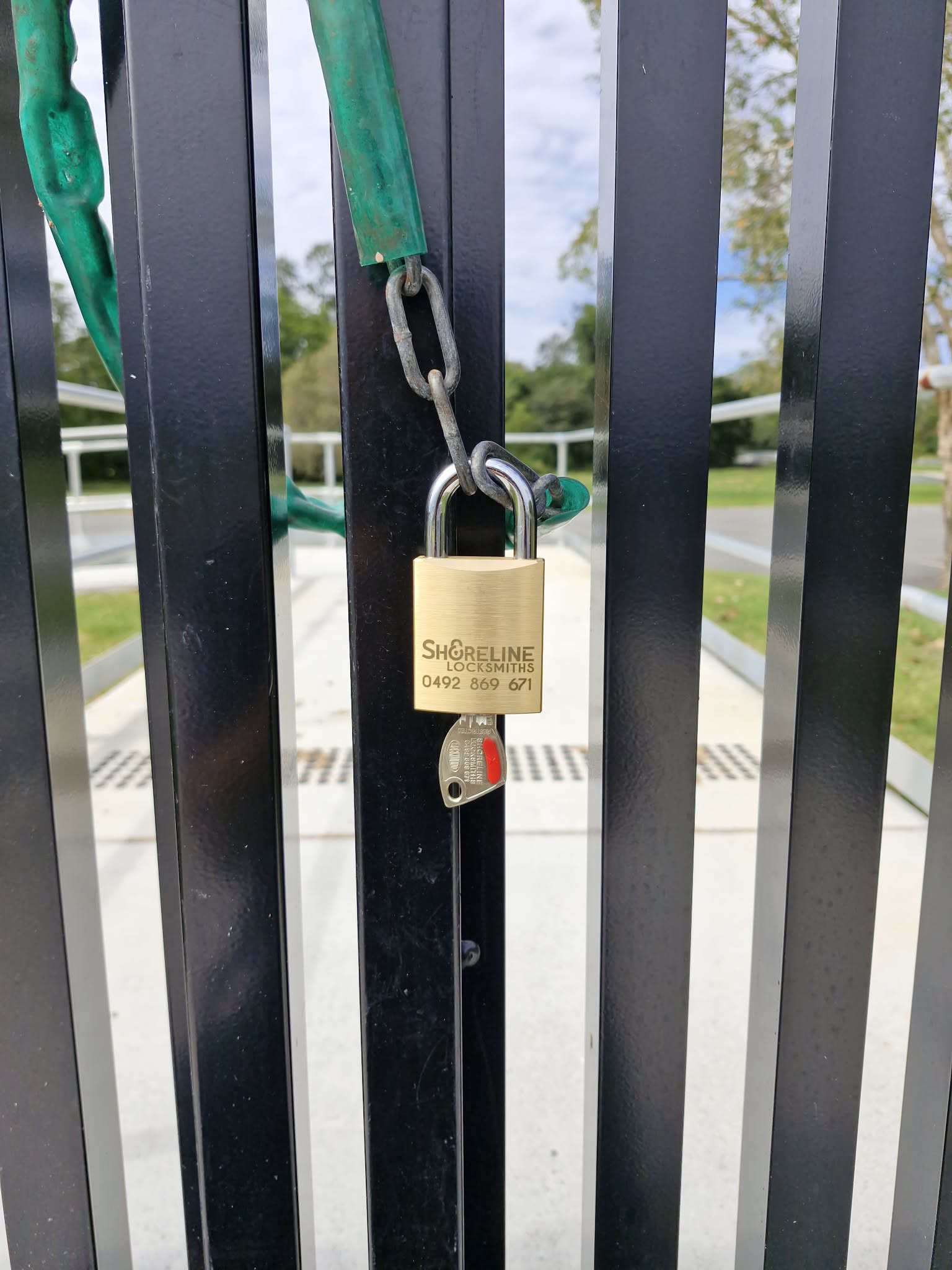 Shoreline Locksmiths padlock on a gate, with a restricted key in the padlock